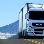 Truck driver hauling LTL shipping freight on a highway