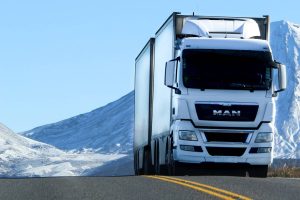 Truck driver hauling LTL shipping freight on a highway