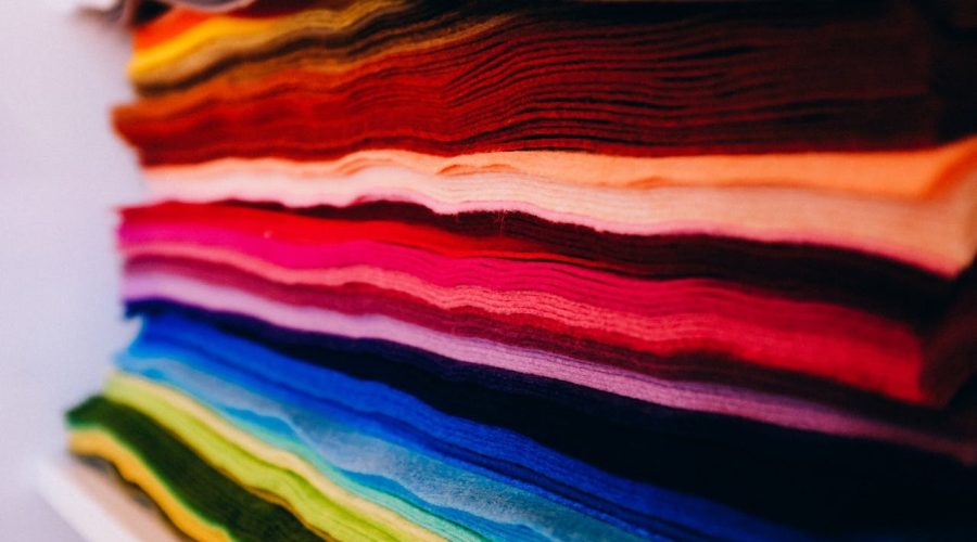 Stack of fabrics in assortment of colors for textile manufacturing