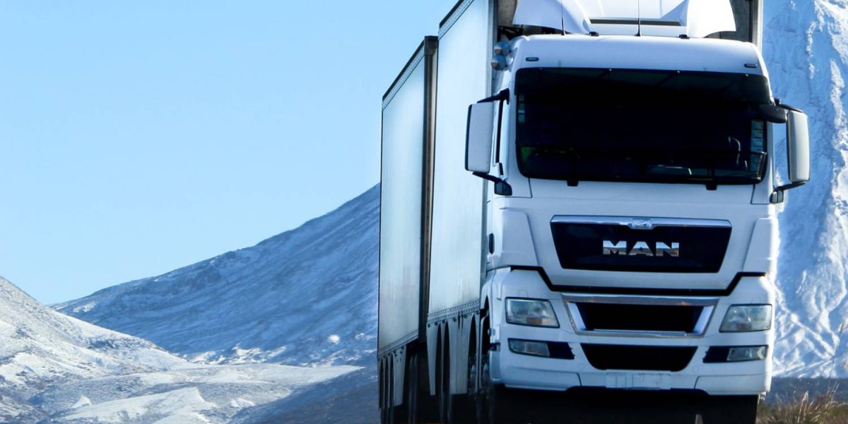 Truck driver hauling LTL shipping freight on a highway